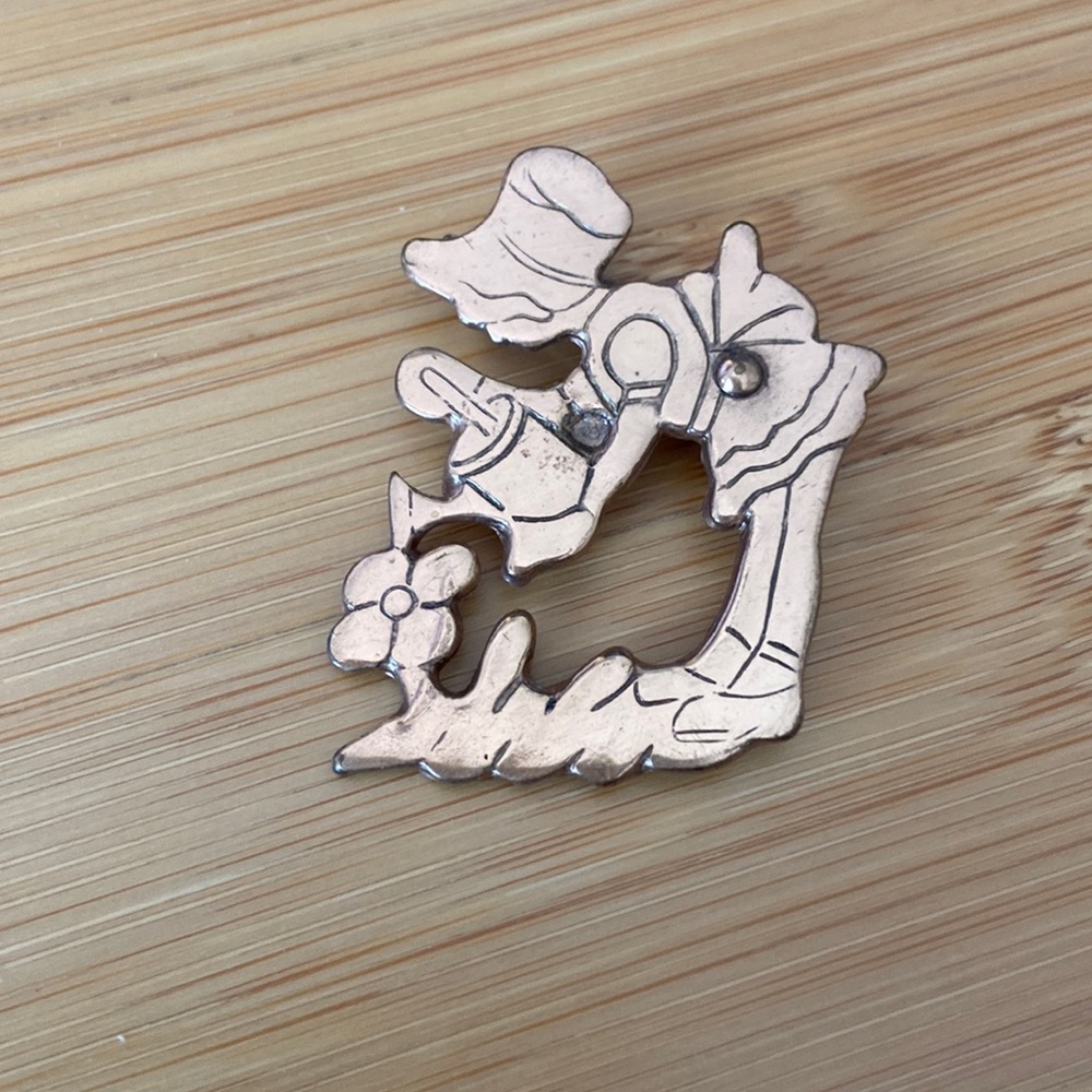 Girl watering flower pin